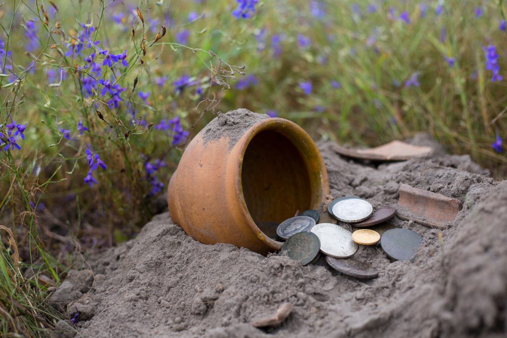 Pot of gold coins collected with help of metal detector, green g